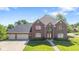 Charming brick home with a manicured lawn and a three-car garage at 4465 W Woodbridge Ln, New Palestine, IN 46163