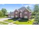 Beautiful brick home featuring a spacious three-car garage and well-maintained landscaping at 4465 W Woodbridge Ln, New Palestine, IN 46163