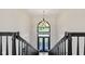 An elevated view of the foyer and its chandelier from the staircase at 4465 W Woodbridge Ln, New Palestine, IN 46163