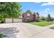 Spacious brick home boasting a three-car garage and large driveway at 4465 W Woodbridge Ln, New Palestine, IN 46163