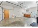 Spacious garage with a work bench, fluorescent lighting, and a roll-up garage door at 4465 W Woodbridge Ln, New Palestine, IN 46163