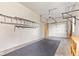 Functional garage features storage, wall mount racks, and an automatic garage door opener at 4465 W Woodbridge Ln, New Palestine, IN 46163