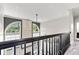 Upper-level hallway with modern lighting, wainscoting detail, and view of the living room at 4465 W Woodbridge Ln, New Palestine, IN 46163