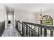 Upstairs hallway with elegant black railings and an arched transom window detail at 4465 W Woodbridge Ln, New Palestine, IN 46163