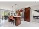 Open kitchen showcasing an island with seating, wood cabinets, and modern appliances at 4465 W Woodbridge Ln, New Palestine, IN 46163
