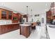 A stylish kitchen with an island, seating, glass cabinets, and stainless steel appliances at 4465 W Woodbridge Ln, New Palestine, IN 46163