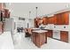 Well-equipped kitchen featuring an island with bar stools, stainless steel appliances, and custom cabinets at 4465 W Woodbridge Ln, New Palestine, IN 46163