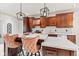 Kitchen island with seating beneath pendant lights, complemented by modern countertops and cabinetry at 4465 W Woodbridge Ln, New Palestine, IN 46163