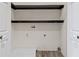 Functional laundry room with utility hookups, vinyl floor and storage shelves at 4465 W Woodbridge Ln, New Palestine, IN 46163