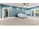 Large bedroom with an ensuite, private balcony, and a decorative accent wall at 4465 W Woodbridge Ln, New Palestine, IN 46163