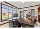 This is a home office with a large window and a leather chair at 4465 W Woodbridge Ln, New Palestine, IN 46163