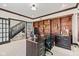 This is a home office with custom built-in shelving and large windows at 4465 W Woodbridge Ln, New Palestine, IN 46163