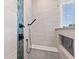 Close-up of a shower with blue accent tiles and black fixtures at 4465 W Woodbridge Ln, New Palestine, IN 46163