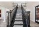 An ascending view of a grand staircase in a home's foyer at 4465 W Woodbridge Ln, New Palestine, IN 46163