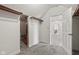 View of walk-in closet with built-in shelving and open doorway to carpeted bonus room at 4465 W Woodbridge Ln, New Palestine, IN 46163