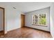 The bedroom features wood flooring, a closet, and a window looking to the outside trees at 4609 Framington Ct, Indianapolis, IN 46254