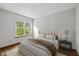 Cozy bedroom with a large window, plush carpeting, and modern furnishings at 4609 Framington Ct, Indianapolis, IN 46254