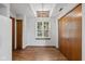 Bright bedroom with wood flooring, a stylish window, and double-door closets for ample storage at 4609 Framington Ct, Indianapolis, IN 46254