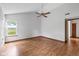Bright bedroom with hardwood floors, a ceiling fan, and a scenic view from the window at 4609 Framington Ct, Indianapolis, IN 46254