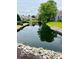 Reflecting the surrounding trees, the backyard pond is beautiful to look at at 4609 Framington Ct, Indianapolis, IN 46254