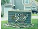 The Cobblestone community sign is surrounded by pink flowers at 4609 Framington Ct, Indianapolis, IN 46254