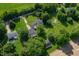 An aerial view of a home surrounded by abundant trees, lush grass, and a sense of tranquil seclusion at 5081 N 500 W, Fairland, IN 46126