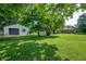 Expansive backyard featuring lush grass, mature trees, and an outbuilding at 5081 N 500 W, Fairland, IN 46126