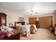 Cozy bedroom with neutral carpet, patterned wallpaper, ceiling fan and furniture at 5081 N 500 W, Fairland, IN 46126