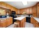 Bright kitchen with light wood cabinets, black appliances, a central island with stool, and decor at 5081 N 500 W, Fairland, IN 46126