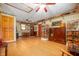 Bright living room with hardwood floors, ceiling fan, and decorative display of baskets and wood furniture at 5081 N 500 W, Fairland, IN 46126