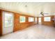 Enclosed sun room featuring wood paneled walls, tile floors, and multiple windows at 5081 N 500 W, Fairland, IN 46126
