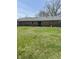 Spacious backyard featuring a well-kept lawn and the rear of the brick home at 5453 David St, Indianapolis, IN 46226