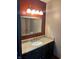 The bathroom has a granite vanity top, dark cabinets and a big mirror at 5453 David St, Indianapolis, IN 46226