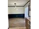 Cozy dining area showcasing modern lights, dark trim, wood floors, and sliding glass doors at 5453 David St, Indianapolis, IN 46226