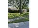 A traditional brick home with lush green lawn, mature trees and an attached two-car garage at 5453 David St, Indianapolis, IN 46226