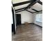 Bright living room with modern wood floors, black trim, ceiling fan, and a front door at 5453 David St, Indianapolis, IN 46226