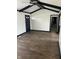 Well-lit room featuring sleek wooden floors, a ceiling fan, and a view of the hallway at 5453 David St, Indianapolis, IN 46226