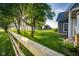 Expansive backyard with lush greenery, a fence, and a gazebo and barn in the distance, bathed in sunlight at 6012 N 200 W, Greenfield, IN 46140