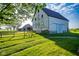 White barn with a metal roof, surrounded by a lush green field at 6012 N 200 W, Greenfield, IN 46140