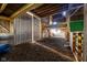Sunlit barn interior with stalls, wooden beams and hay covered floor at 6012 N 200 W, Greenfield, IN 46140