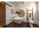 Stylized bathroom featuring tub, toilet, vanity and sliding barn door at 6012 N 200 W, Greenfield, IN 46140