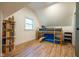 Bedroom featuring a bunk bed, bookshelves, and wood-look flooring, maximizing space in a charming setting at 6012 N 200 W, Greenfield, IN 46140