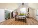 Cozy bedroom with wood floors, a single bed, and a unique pet door for added convenience at 6012 N 200 W, Greenfield, IN 46140