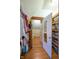 Closet with hanging clothes leading to a bathroom with a shower curtain and vanity at 6012 N 200 W, Greenfield, IN 46140