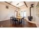Dining room with hardwood floors, wood table, and a wood-burning stove at 6012 N 200 W, Greenfield, IN 46140