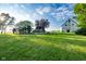 Expansive backyard featuring a playground, gazebo, barn, and lush green grass under a partly cloudy sky at 6012 N 200 W, Greenfield, IN 46140
