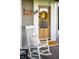 Welcoming front porch showcases a classic rocking chair and decorative wreath on the front door at 6012 N 200 W, Greenfield, IN 46140