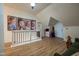 Bright upstairs hallway with Gathering photos and painted railing at 6012 N 200 W, Greenfield, IN 46140