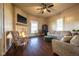 Inviting living room featuring a decorative fireplace, ceiling fan, plush seating, and hardwood floors at 6012 N 200 W, Greenfield, IN 46140