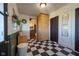 Mud room featuring checkered floors, built-in storage, wooden accents, and access to other rooms at 6012 N 200 W, Greenfield, IN 46140